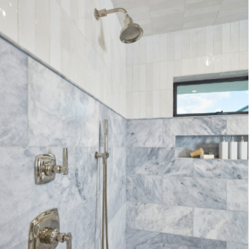 Custom shower with blue quarts shower tile walls 3/4 of the way up. Vertially installed white subway tiles above and on ceiling.