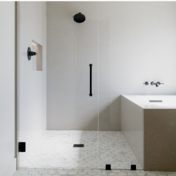 Clean white modern bathroom with square tub inside glass doors with the shower.