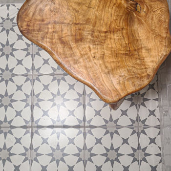 Grey and white star shapes decorative porcelain floor tile in shower with white subway tiles for the wall. Installation by GWH Flooring in Wimberley.