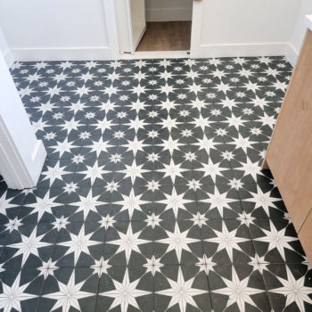 Black and white artistic star floor tiles. Installation by GWH Flooring.