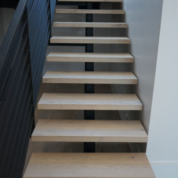 White oak floating staircase. Installation in Driftwood by GWH Flooring company.