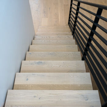 White oak floating staircase. Installation in Driftwood by GWH Flooring company.