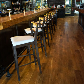 European White Oak Floor with dark finish and custom made wood bar installed in Buda restaurant, Brooklyn's. Installation by GWH Flooring company