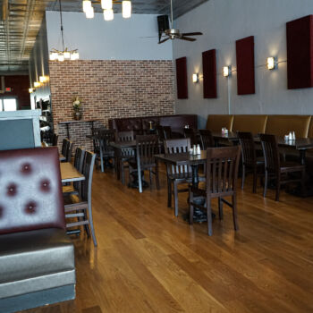 European White Oak Floor with dark finish installed in Buda restaurant, Brooklyn's. Gold booths, Dark tables and chairs, white walls with burgandy sound panels Installation by GWH Flooring company