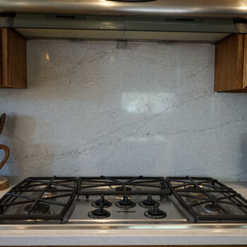 Grey quartz backsplash and countertop in the Texas hill country. Installation by GWH Flooring company