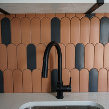 Terracotta and black popcycle tiles with gold grout installed in Wimberley by GWH Flooring store and contractors