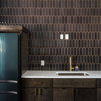 Unique brown tile backsplash with gold grout. Installed by GWH Flooring in Wimberley, Texas
