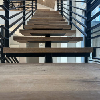 Wood floating stairs installed in Driftwood by GWH Flooring