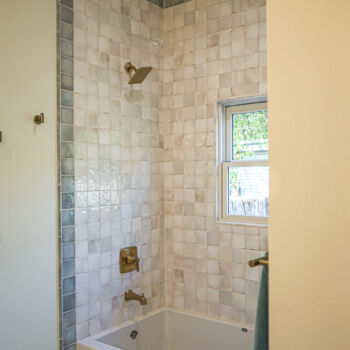 Zia tile shower, blue border with white installed by GWH Flooring