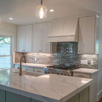 Renovated kitchen in San Marcos, Texas. Tile backsplash and quartz countertops